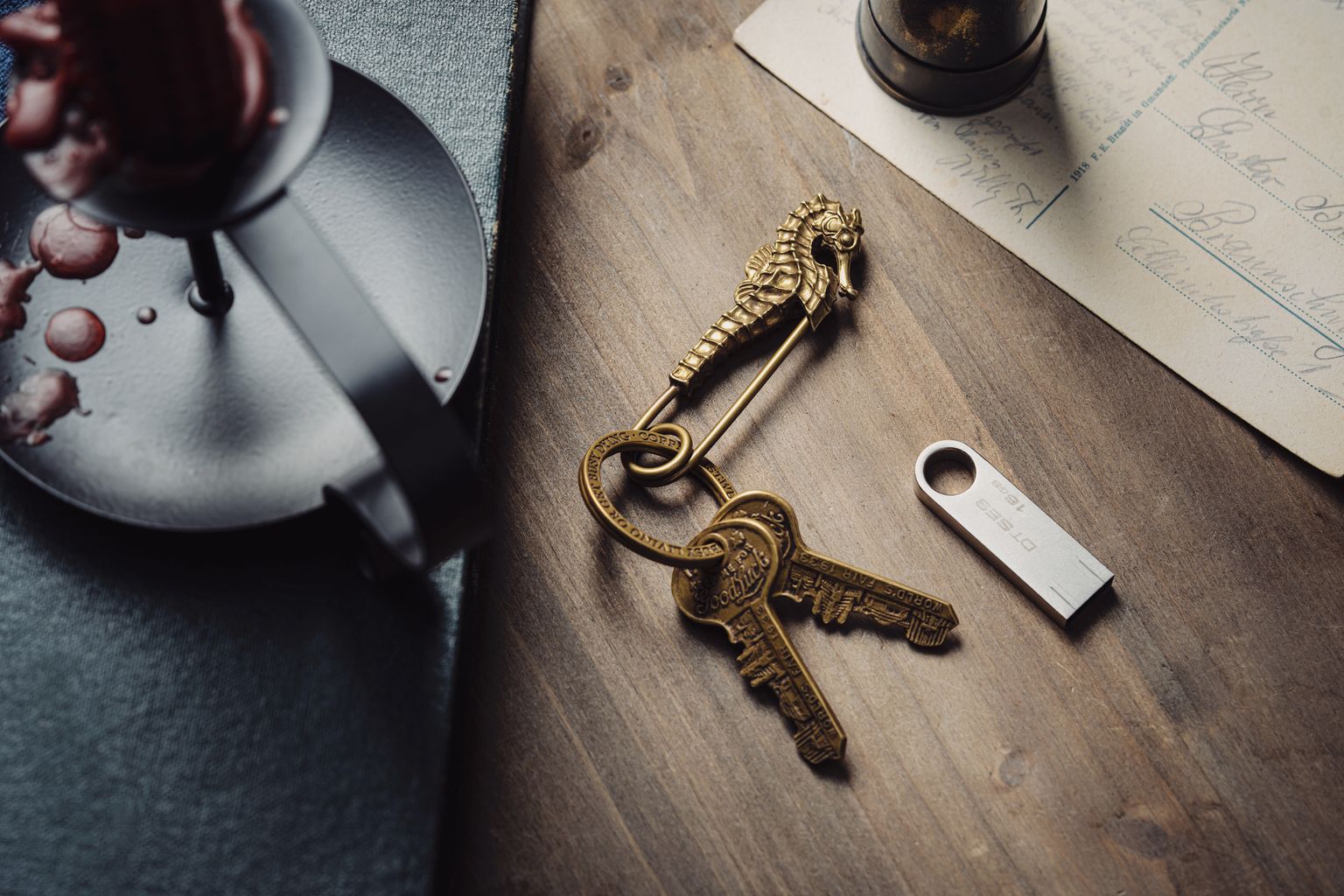 Brass vintage keys with a seahorse keyring beside a wax-sealed letter and a paper document on a warm wooden surface — a metaphor for the preparation involved in handing the business to the next generation.